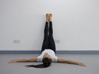 © Jantira - Yoga woman feet up relaxing on wall background