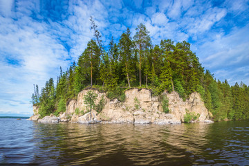 Wall Mural - panoramic view of the rocky cliff near the river kama, blue sky with white clouds.