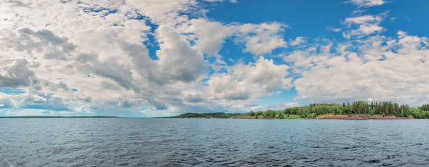 Wall Mural - panorama of calm lake, kama river blue sky with clouds reflected in the water.