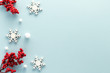 © siggi1956 - Christmas composition. Snowflake holly berries top view background with copy space for your text. Flat lay.