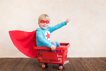 Wall Mural - Happy superhero child playing at home