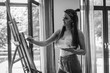© sushytska - young beautiful girl paints a picture on an easel