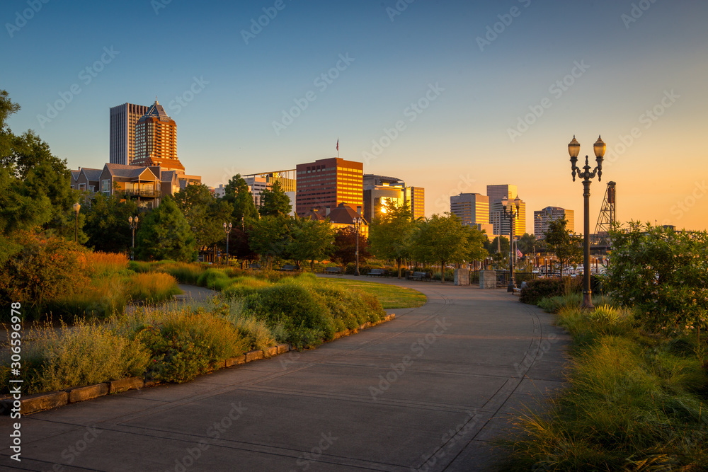 South Waterfront Park in Downtown Portland, Oregon, USA during beautiful sunrise with yellow glow and clear blue sky - obrazy, fototapety, plakaty 