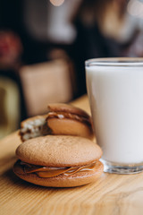 Poster - Close up Traditional chocolate and Pumpkin Whoopie pies filled made with vanilla cream cheese in cozy cafe background