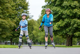 A young mother roller skating with her son