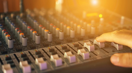 male sound engineer hands working, sound recording studio mixing desk with engineer or music producer