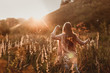 © natalialeb - caucasian girl with long hair in field at sunset