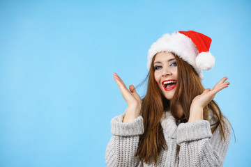 Funny surprised woman in Christmas Santa hat