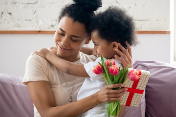 Wall Mural - Happy african American mom hug little boy congratulating her