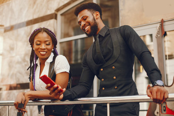 A stylish and beautiful dark-skinned couple in a city