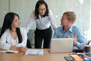 Wall Mural - business people discussing on performance revenue in meeting. businessman working with businesswoman.