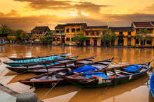 Traditional Boats In Front Of Ancient Architecture In Hoi An, Vietnam.