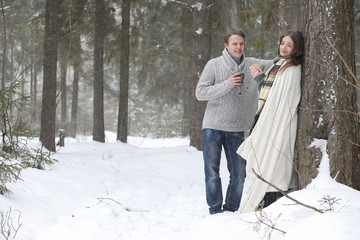 pair of lovers on a date winter afternoon in a snow blizzard