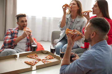 Wall Mural - Group of friends eating tasty pizza at home