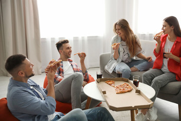 Wall Mural - Group of friends eating tasty pizza at home