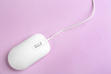 Modern Wired Optical Mouse On Lilac Background, Top View