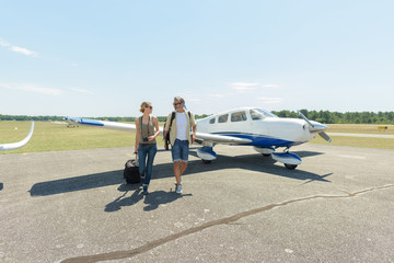 beautiful romantic couple walking near the aircraft