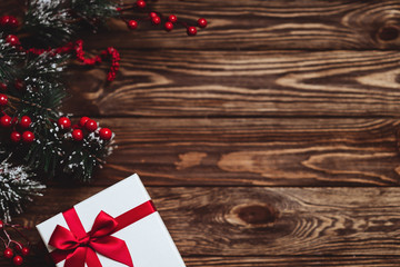 Christmas presents with red ribbon on dark wooden background in vintage style