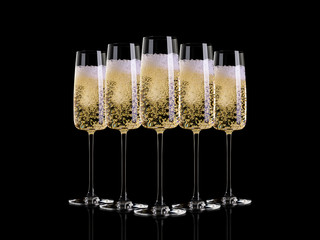 Five glasses of champagne on a dark background.