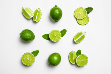  Flat lay composition with fresh juicy limes and mint on white background