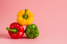 Colorful Bell Peppers Pyramide Heap On Pink Background Copy Space