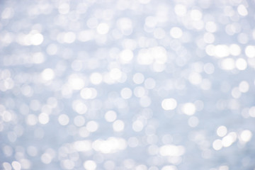 Beautiful abstract background bokeh sun light reflections on blue river surface water