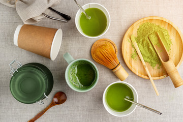 Wall Mural - Matcha tea making process, wooden and bamboo kitchen utensils, metal straws on linen beige background, healthy food Concept, detox drink