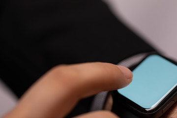 Close up of Businessman's hand looking at hand watch