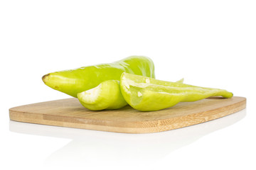 Wall Mural - Group of one whole two halves of hot green pepper banana on bamboo cutting board isolated on white background