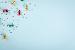 Colored confetti and air balloons composition on blue background, party and celebration decoration.