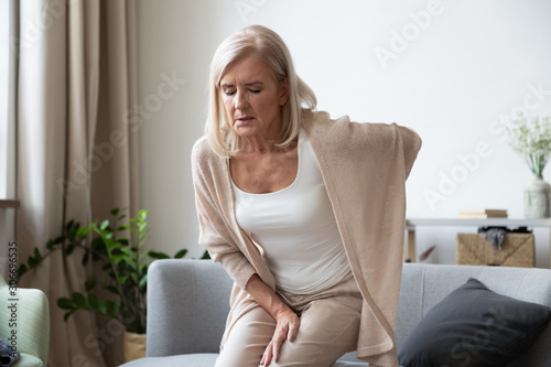 Fotomural Elderly 60s woman suffer from back ache