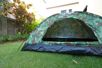 tent camping on green grass lawn campsite, equipment for trip backpack journey travel in nature