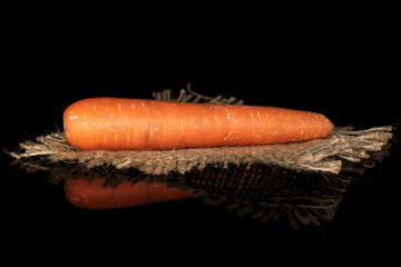 Poster - One whole fresh orange carrot with jute fabric isolated on black glass