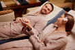 © alfa27 - Caucasian married couple lying on spa beds togeher and take hands of each other, in love