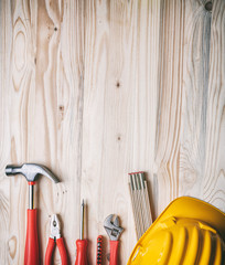 Poster - Tools, hardhat on wooden desk, top view.