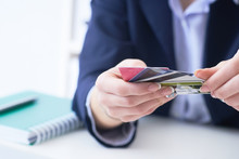 Businesswoman With Many Different Credit Cards In Hands Close-up. Cashless Payments, Anti-fraud And Financial Security, Entering Client Discount Program Number, Filling Personal Information Concept.
