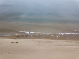 Wall Mural - seaside beach with water covered in fog mist