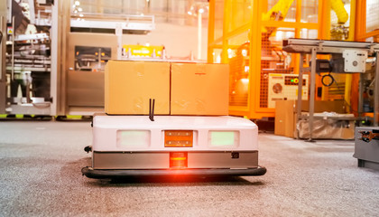 warehouse robot car carries cardboard box assembly in factory