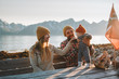 Happy family outdoor mother and father with baby together vacations parents with child healthy healthy lifestyle mountains view travel in Norway