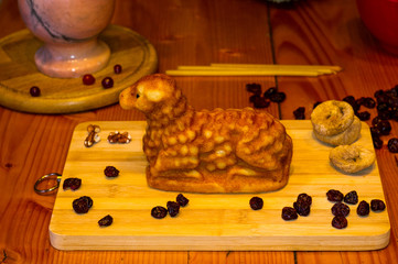 Wall Mural - preparation of treats for traditional Orthodox Christmas - handmade baked cookies in the form of lambkin, dried fruits, cranberries, honey, nuts, rice pudding, mortar with poppy seeds, Church candles