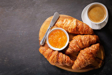 Wall Mural - breakfast with cup of coffee, croissants and orange jam, top view