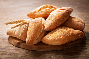 Sticker - fresh bread with wheat ears on a wooden board