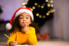 Thoughtful African Girl Thinking What To Ask From Santa Claus