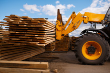 Forklift Loads The Boards In The Lumber Yard