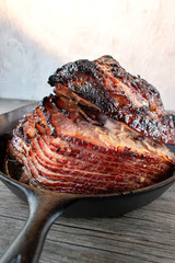Wall Mural - slices of rustic holiday honey glazed baked ham in cast iron pan