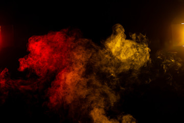 Wall Mural - red and yellow smoke clouds with stage lights on black background