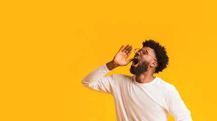 African american man in glasses screaming with excitement