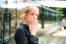 Middle Aged Woman Smoking Cigarette