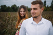 © Serhii - A girl and a guy are walking in the nature. Portrait of a couple, a love story.Happy smiling, loveing couple together outstretched at beautiful nature. Lovestory