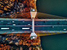 Beautiful Panoramic Aerial Drone View To Cable-stayed Siekierkowski Bridge Over The Vistula River And Warsaw City Skyscrapers, Poland In Gold Red Autumn Colors In November Evening At Sunset - Top Down